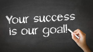 A person drawing and pointing at a Your Success is our goal Chalk Illustration